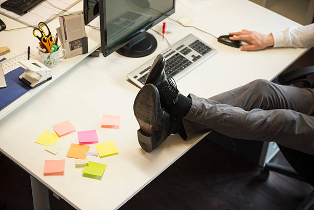 Image of an Office Worker with his feet on the Desk